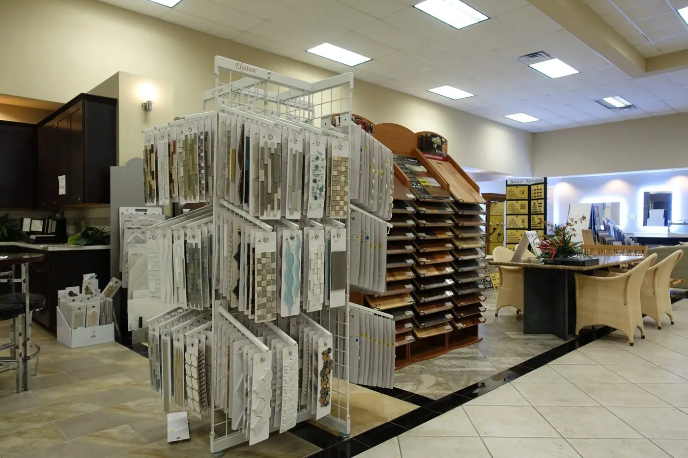 Glass and stone mosaic tile samples next to hardwood displays